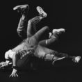 David Yi breakdancing with his feet in the air.