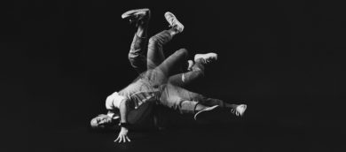 David Yi breakdancing with his feet in the air.