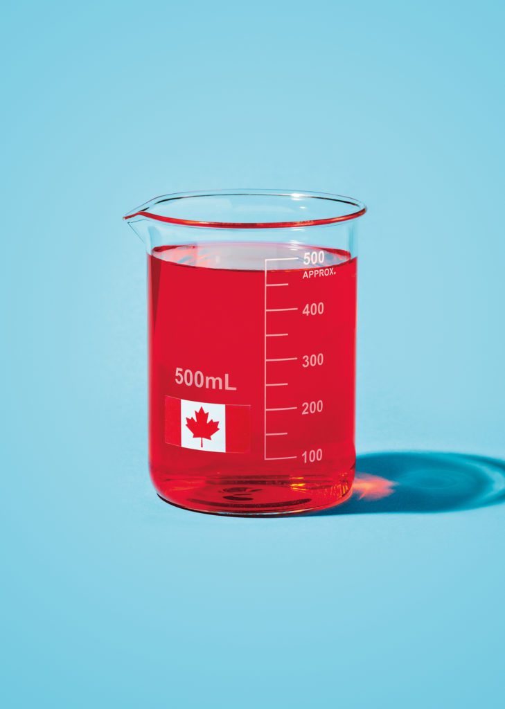 Image of a 500ml beaker with a Canadian flag on it with red liquid filled to the top