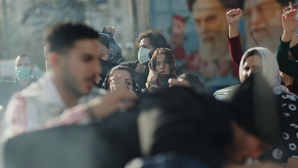 Image from the series Tehran featuring a crowd of people gathering in the street