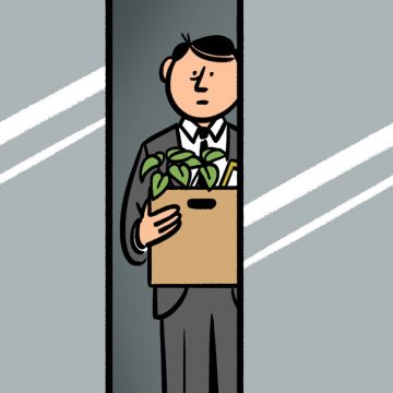 Man in a suit holding a box in an elevator